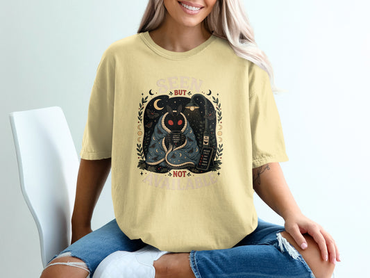 Seen but not available moth graphic on yellow t-shirt with moon phases.