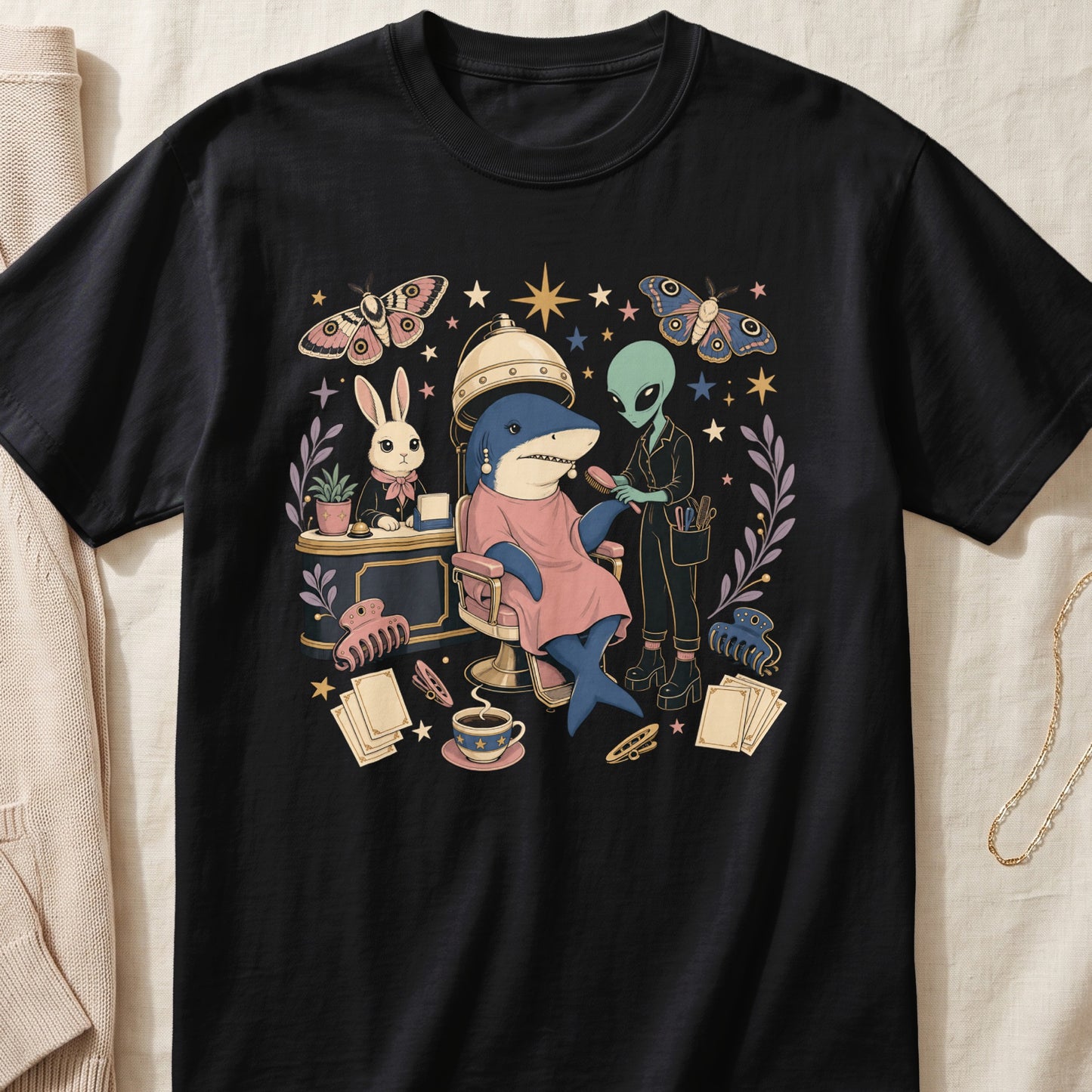 Black t-shirt featuring a surreal graphic of a shark getting its hair brushed by an alien.