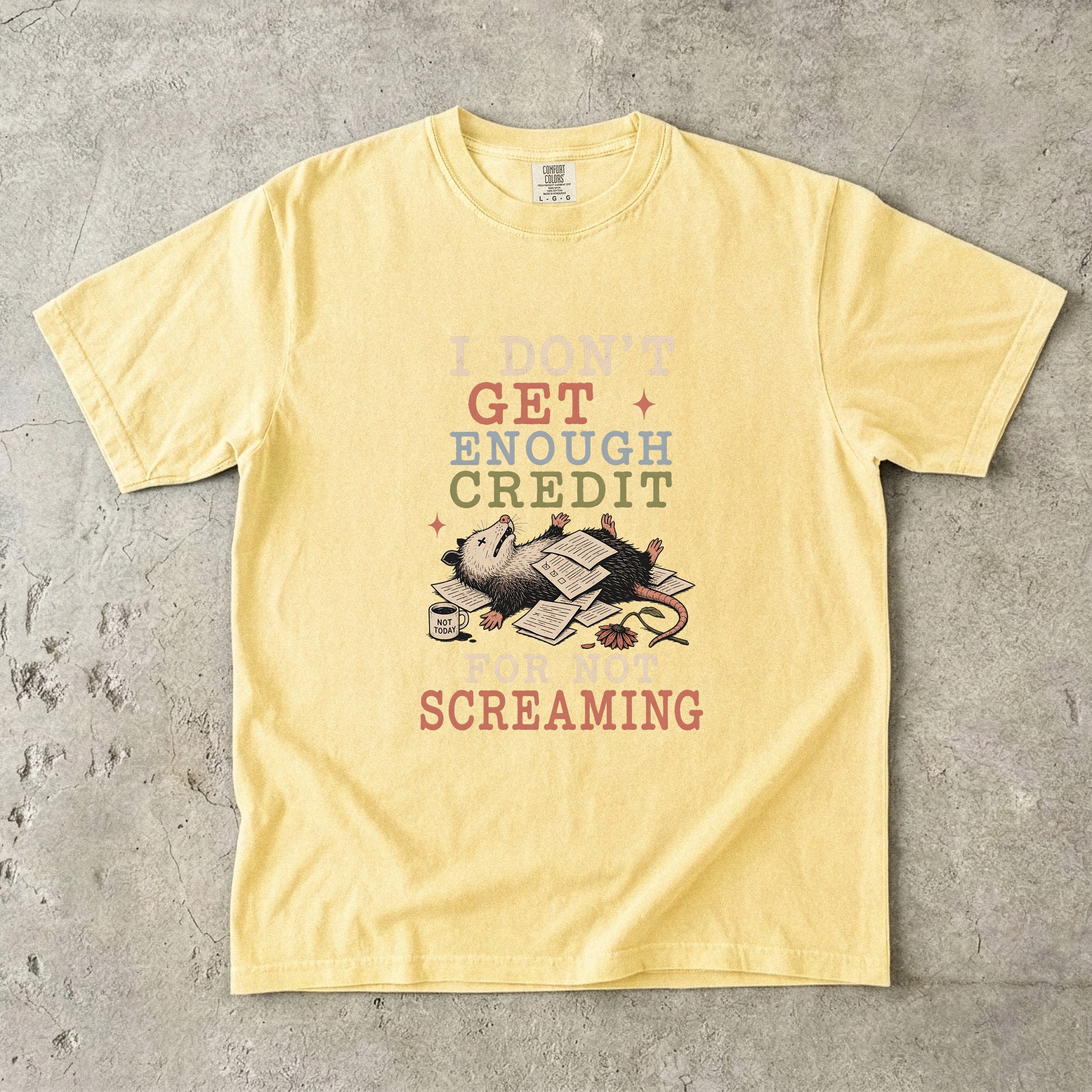 Yellow t-shirt with opossum on papers, text "I DON'T GET ENOUGH CREDIT FOR NOT SCREAMING".