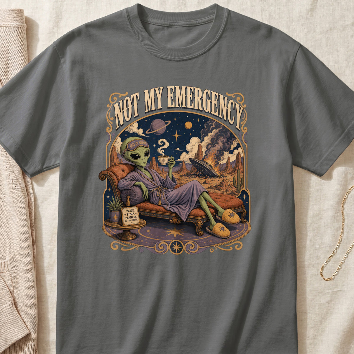 Alien drinking coffee on chaise lounge with text "NOT MY EMERGENCY" and desert landscape.