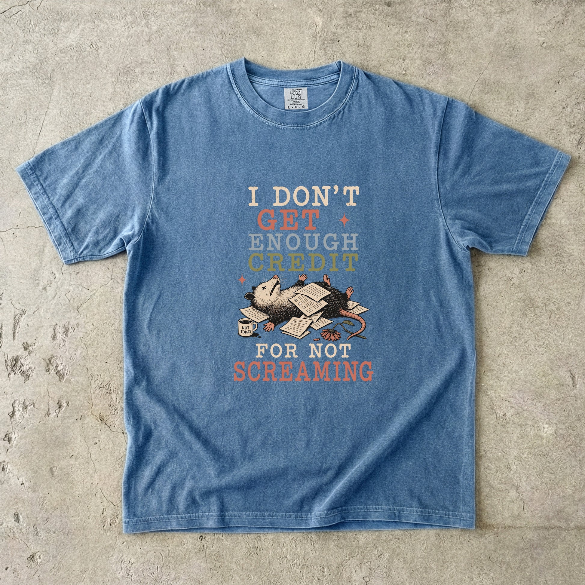 Blue t-shirt with graphic of possum and text "I DON'T GET ENOUGH CREDIT FOR NOT SCREAMING".