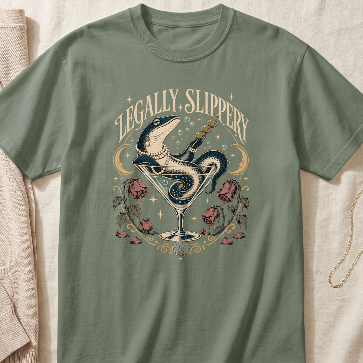 A lizard in a martini glass with pearls and olives, text "Legally Slippery".