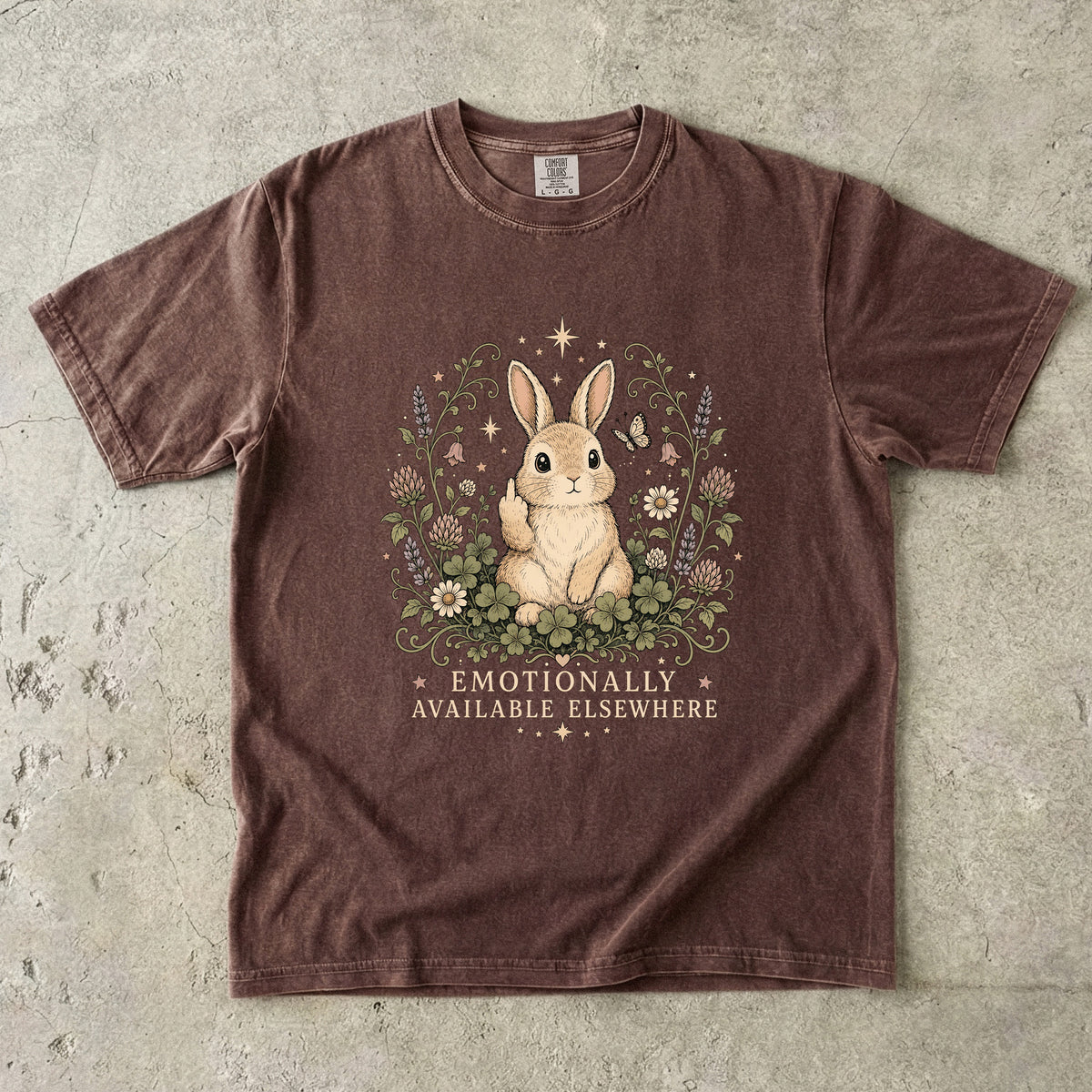 Brown t-shirt with a rabbit giving the middle finger and text "EMOTIONALLY AVAILABLE ELSEWHERE".