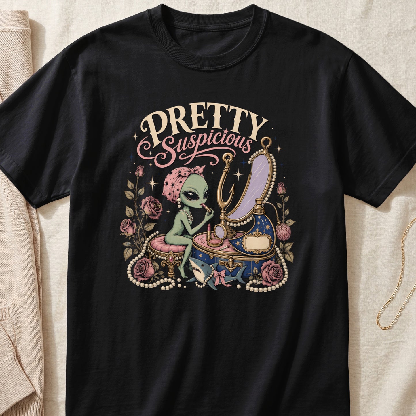 Alien applying makeup with "Pretty Suspicious" text, roses, and shark.
