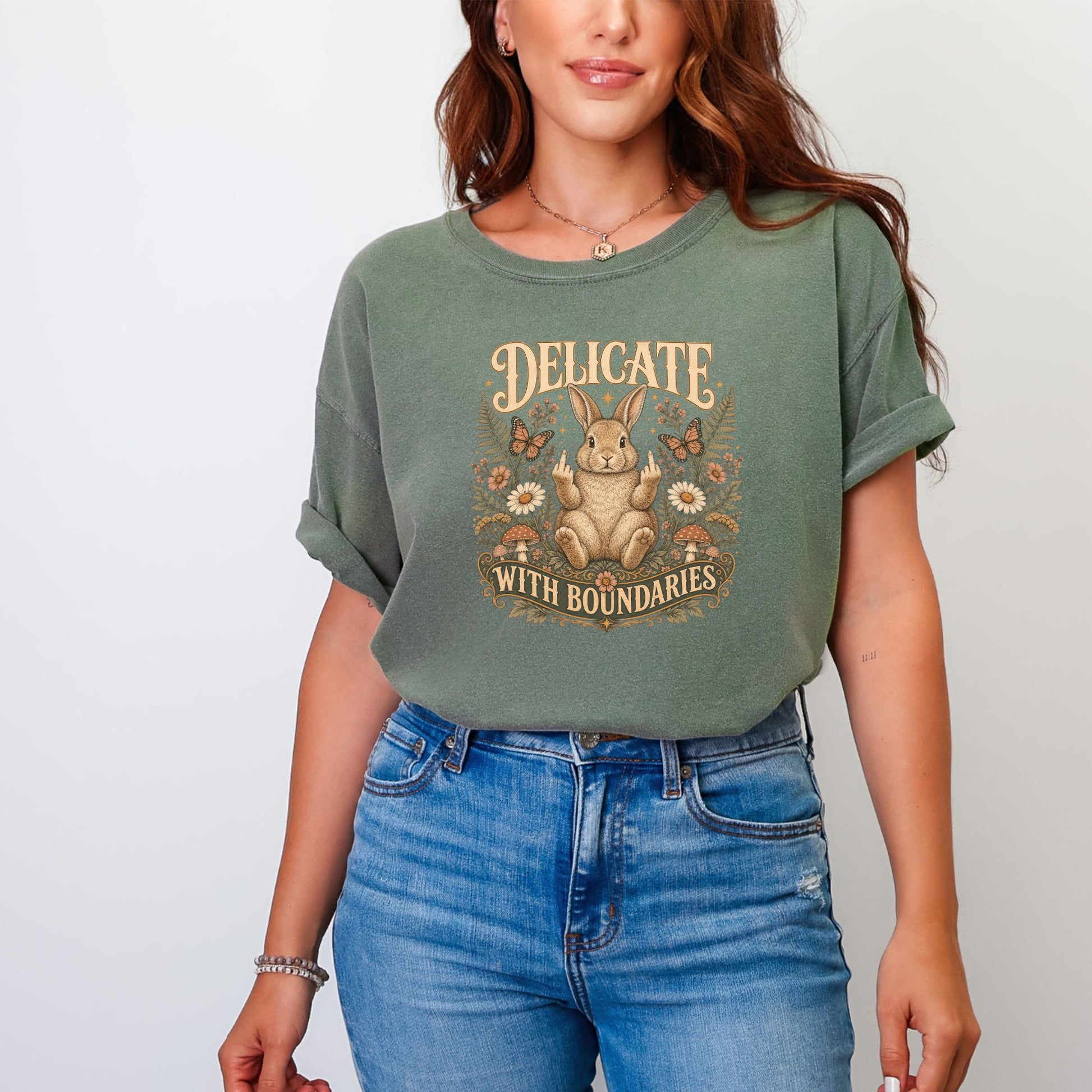 Green t-shirt with a rabbit graphic and text "DELICATE WITH BOUNDARIES".