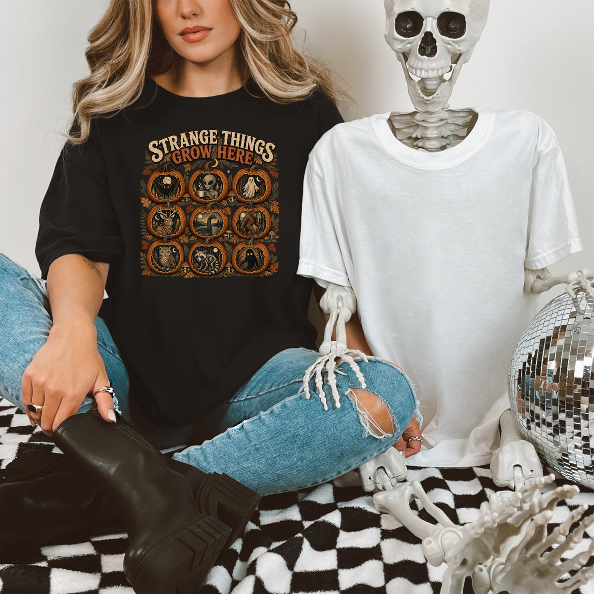 Black t-shirt with "Strange Things Grow Here" and pumpkin Halloween themed illustrations.