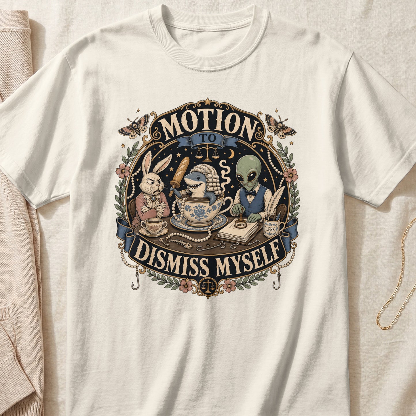 An off-white t-shirt featuring an ornate graphic of a rabbit, shark in a teacup, and alien in a courtroom.