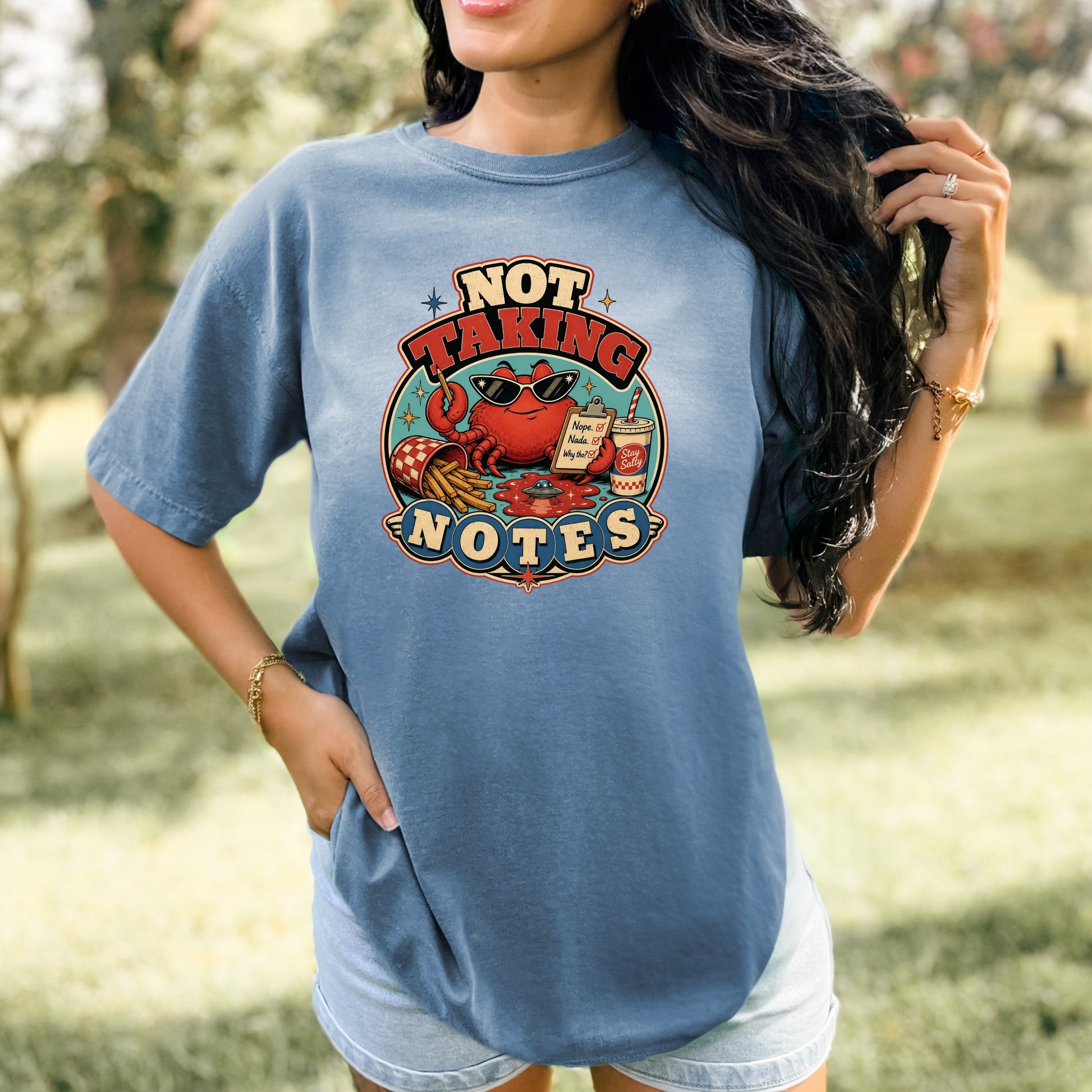 Graphic t-shirt with a crab, french fries, and soda, saying "Not Taking Notes."