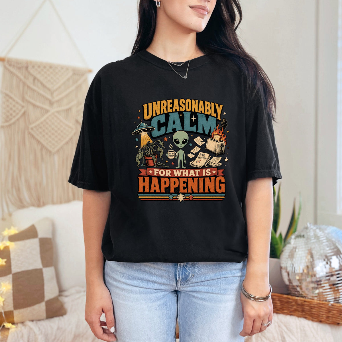 Black t-shirt graphic with alien and toaster saying "Unreasonably Calm for What is Happening".