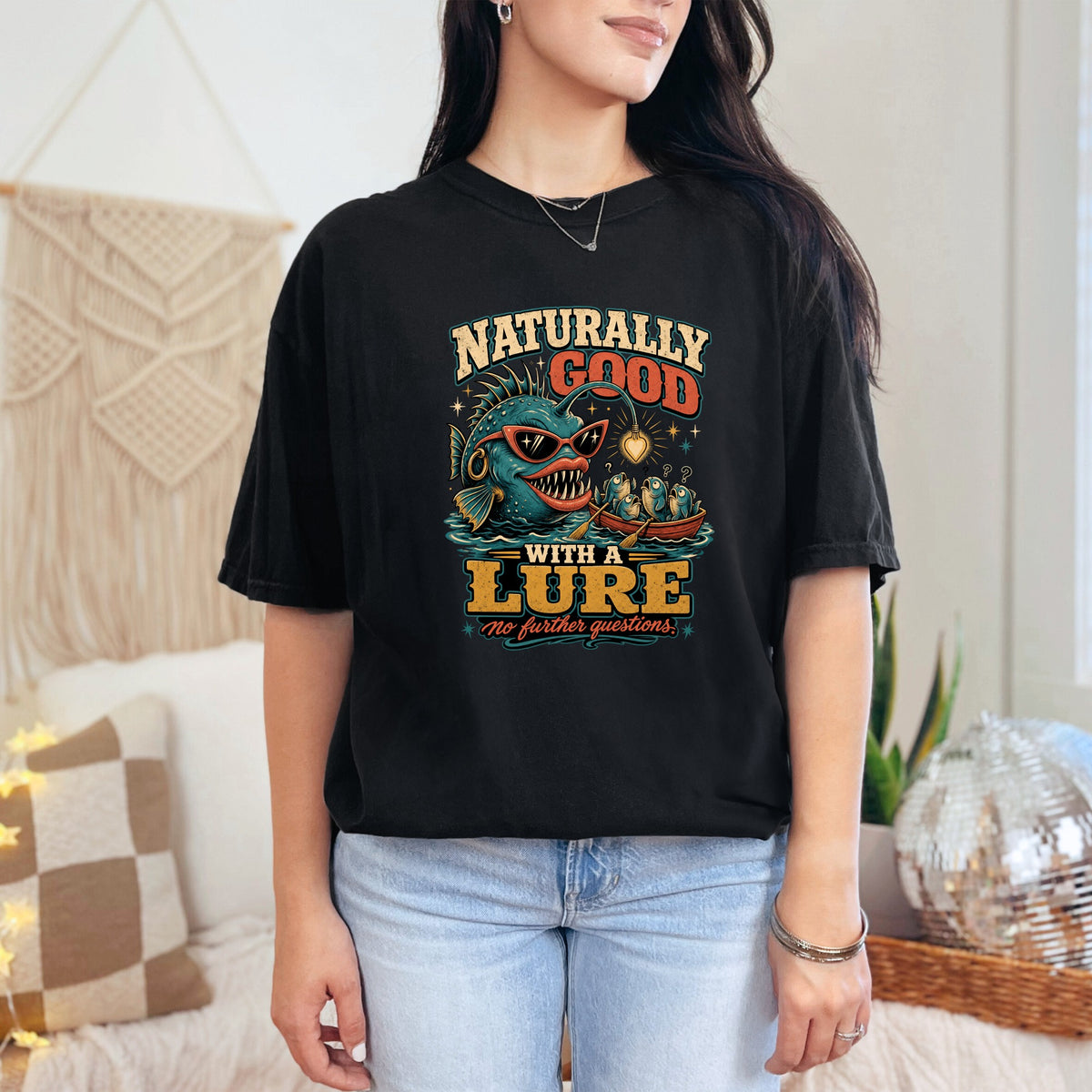 Black t-shirt with graphic: "Naturally Good With A Lure, No Further Questions."