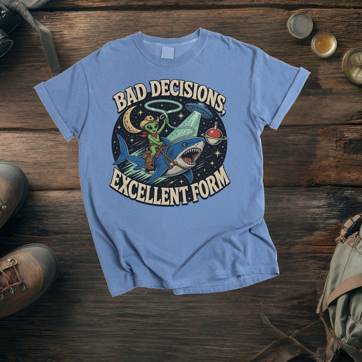 Alien cowboy riding a shark under a moon with text "BAD DECISIONS, EXCELLENT FORM".