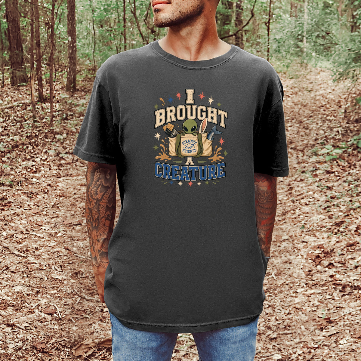 Graphic tee with text "I brought a creature" featuring an alien and friends.