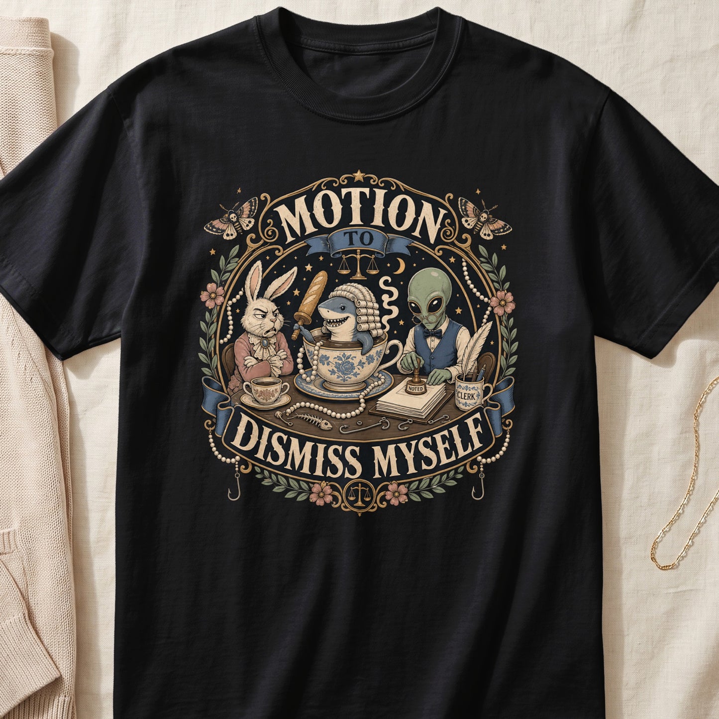 Black t-shirt featuring an ornate graphic of a rabbit, shark in a teacup, and alien with text reading MOTION TO DISMISS MYSELF.