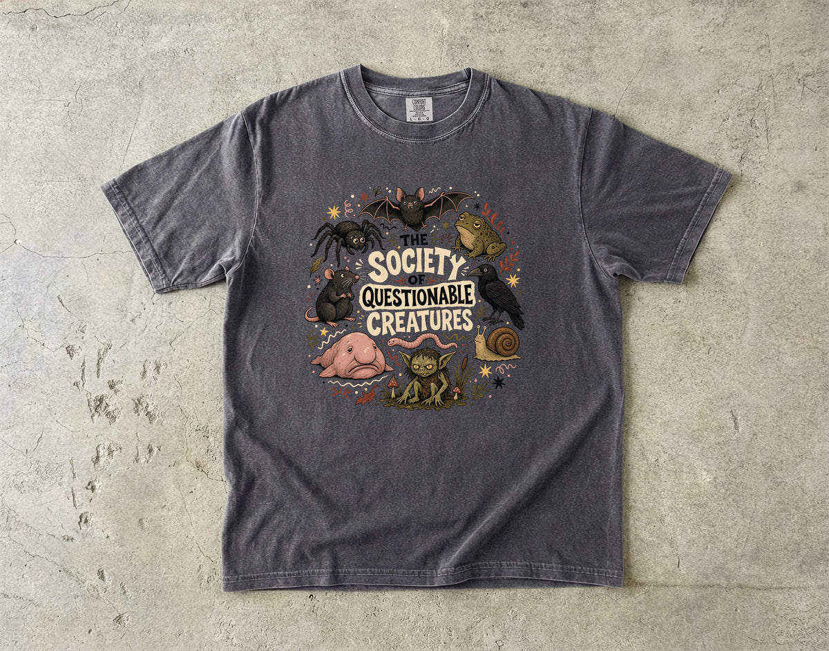 Dark grey t-shirt with graphic of various "questionable creatures" and text.