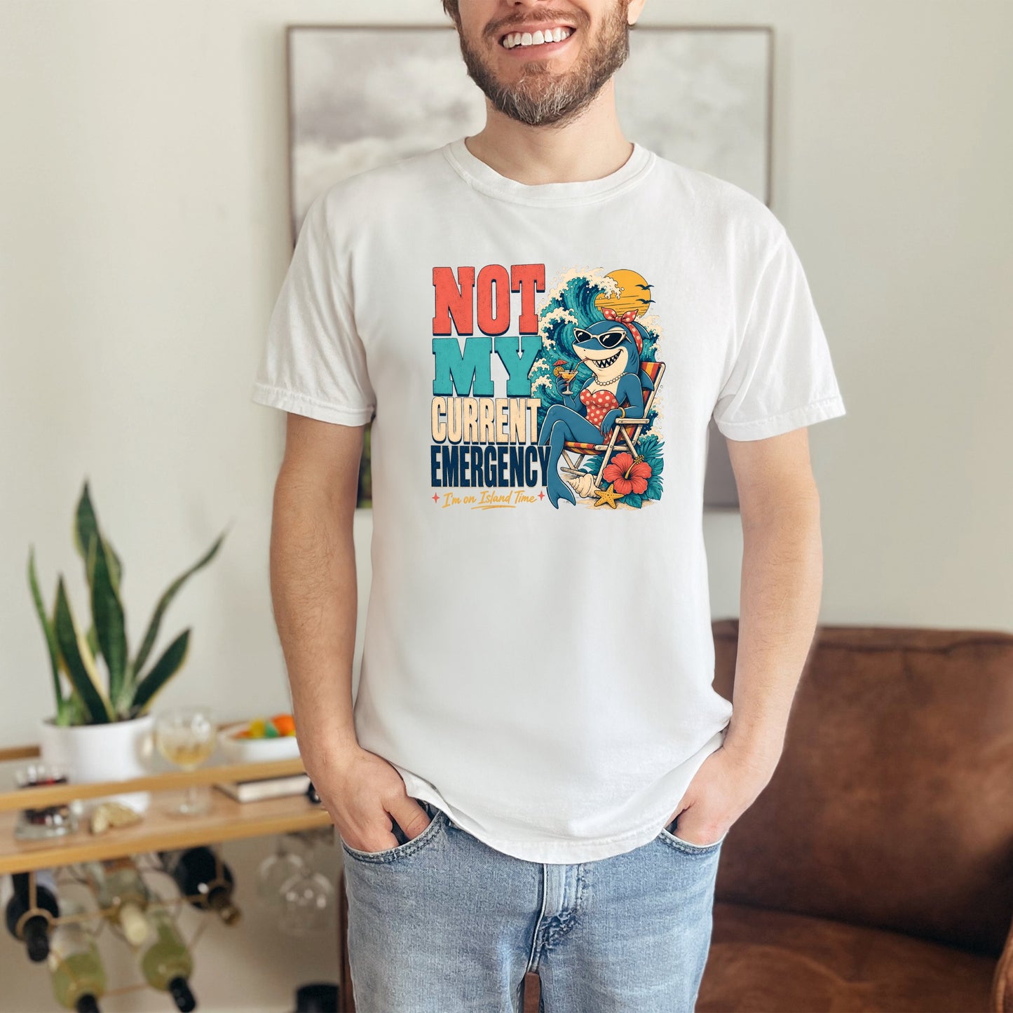 White t-shirt with "Not My Current Emergency I'm on Island Time" text and a shark graphic.