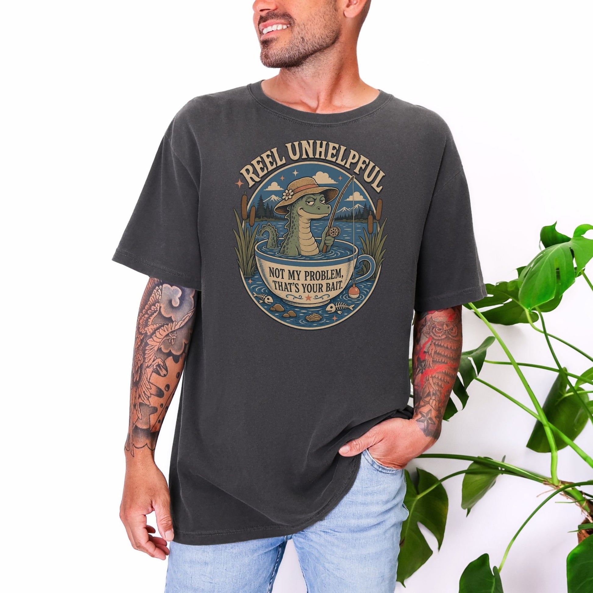 T-shirt with illustration of alligator fishing in a teacup, text "Reel Unhelpful."