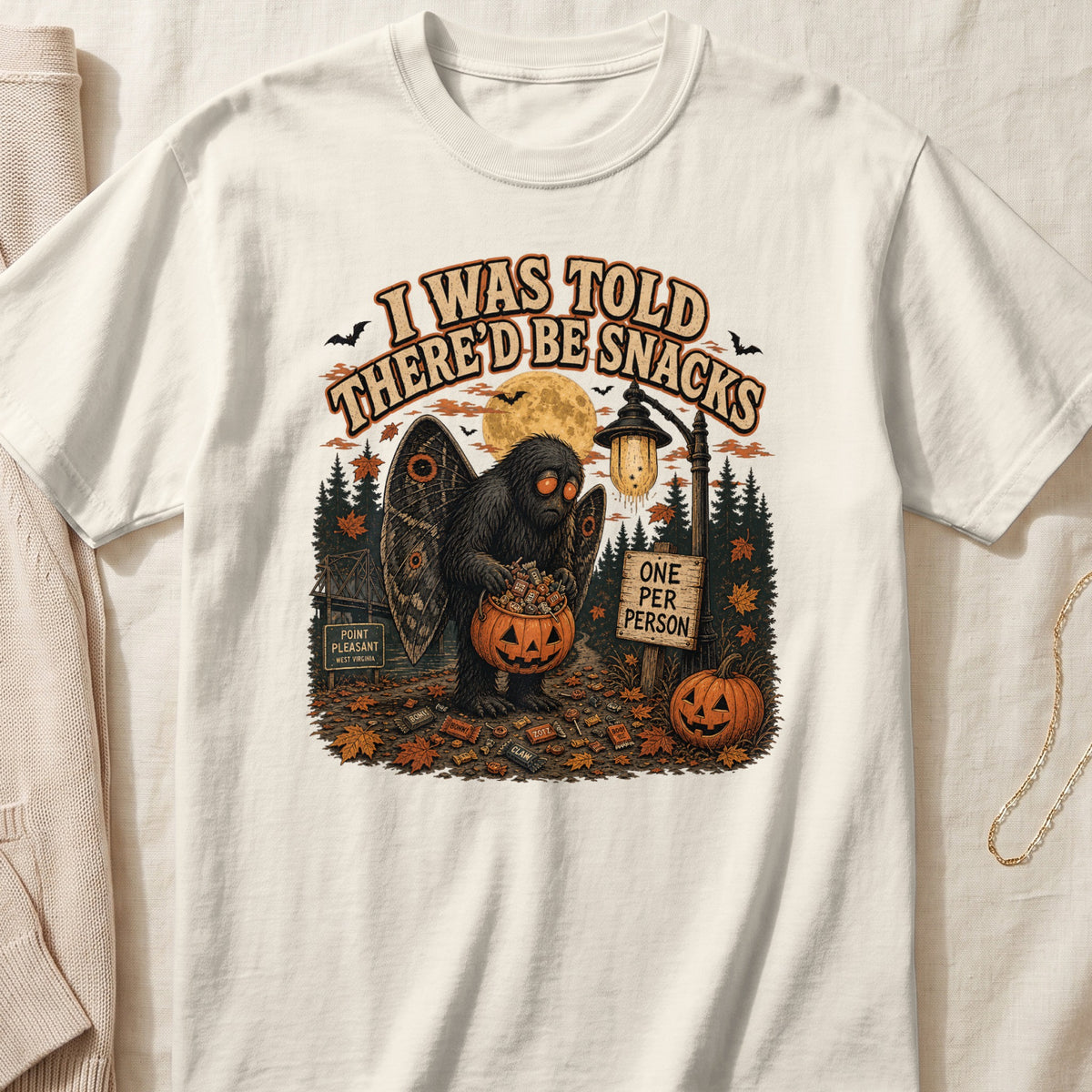 Mothman holding a pumpkin full of candy, with text "I WAS TOLD THERE'D BE SNACKS."