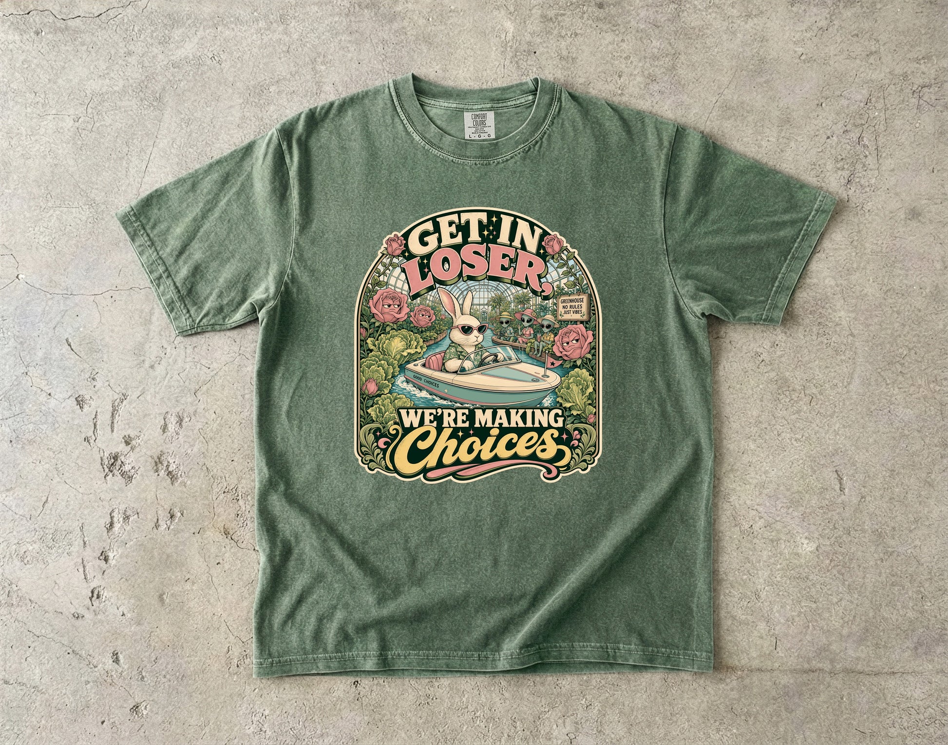 Green t-shirt with rabbit in a boat and aliens saying "Get in loser, we're making choices."