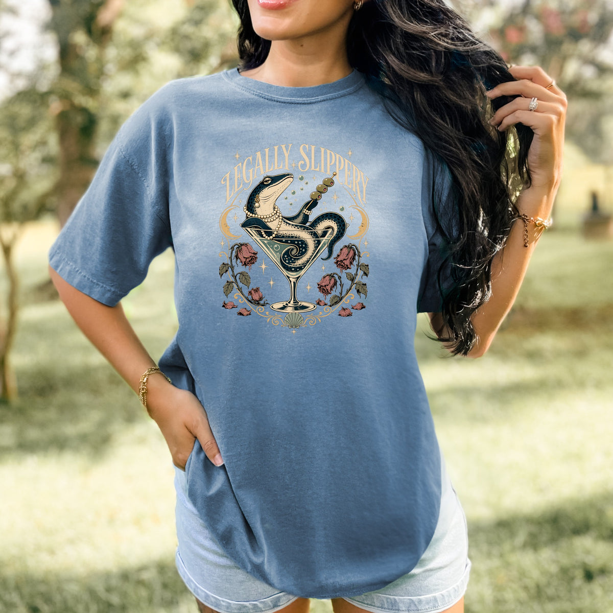 Graphic t-shirt with snake in martini glass and text "LEGALLY SLIPPERY".