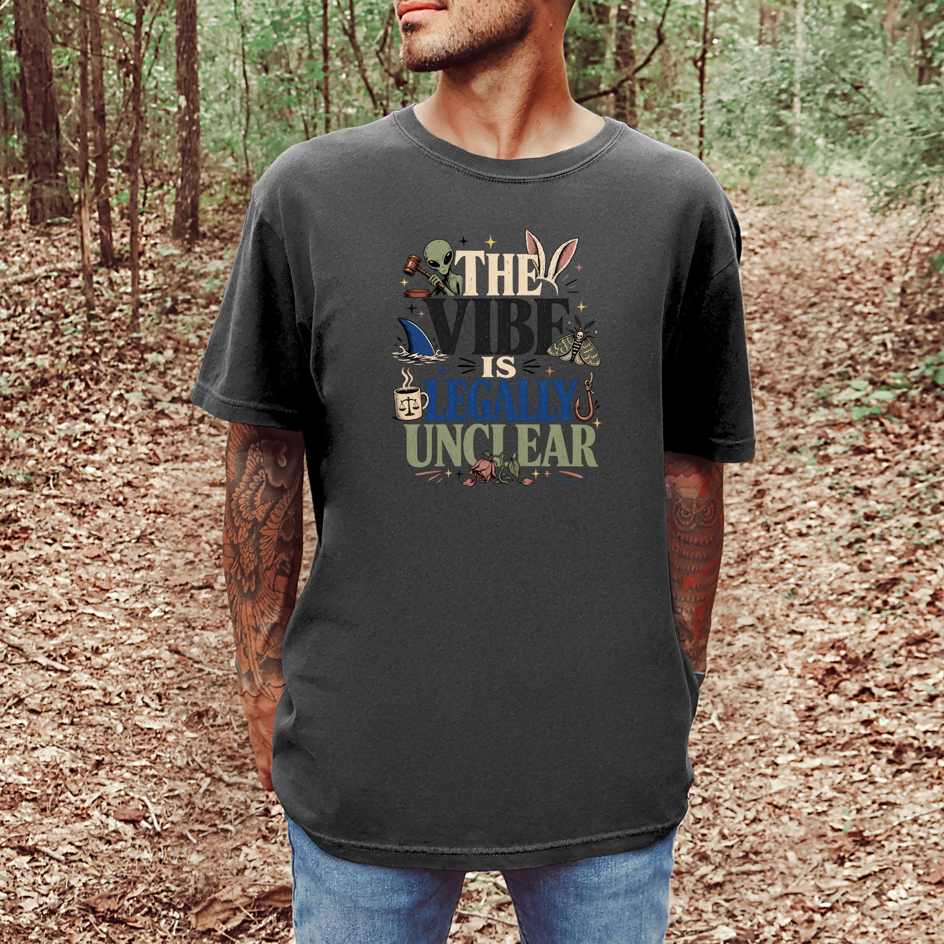 Dark gray t-shirt with "The Vibe Is Legally Unclear" and quirky illustrations.