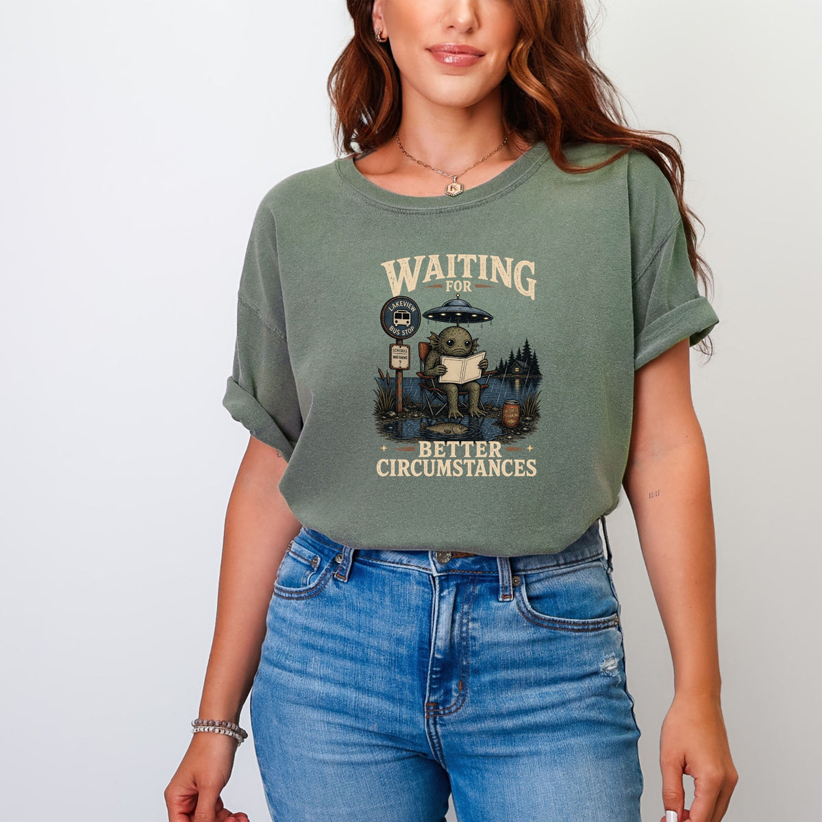 Green t-shirt graphic with text "Waiting for Better Circumstances" and an alien.