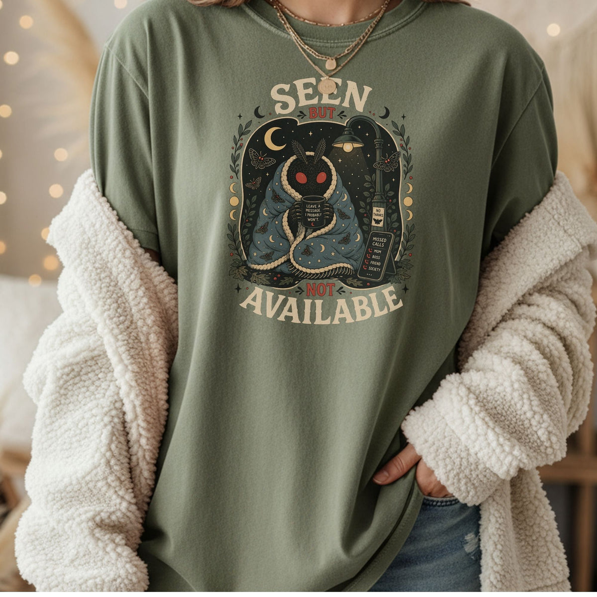 Moth character wrapped in a blanket holding coffee mug with "Seen But Not Available" text.