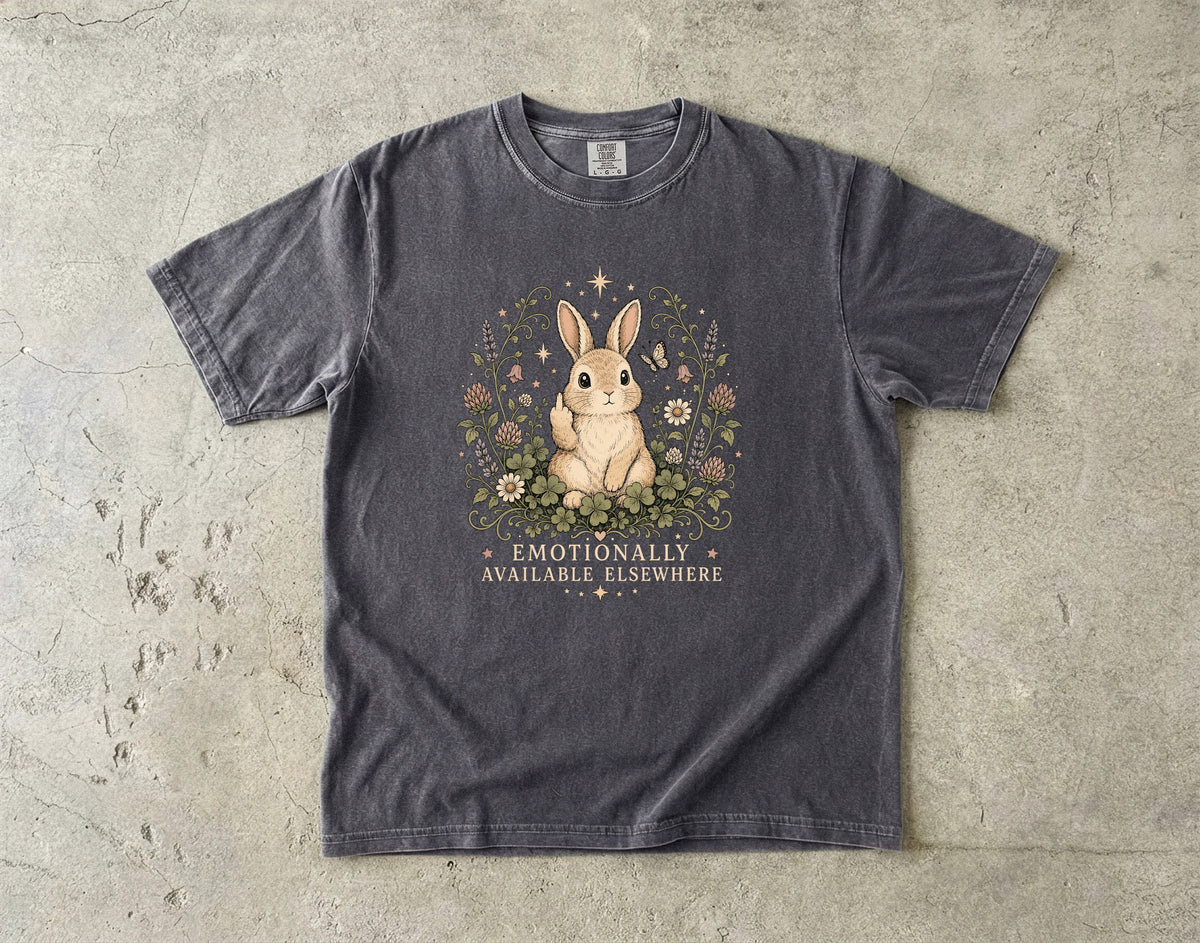 Dark grey t-shirt with a rabbit and text "EMOTIONALLY AVAILABLE ELSEWHERE" on the front.