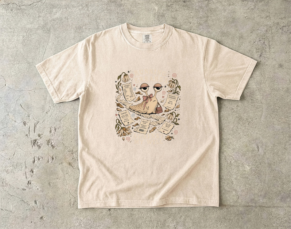 T-shirt with a cartoon snail surrounded by receipts and wilting flowers.