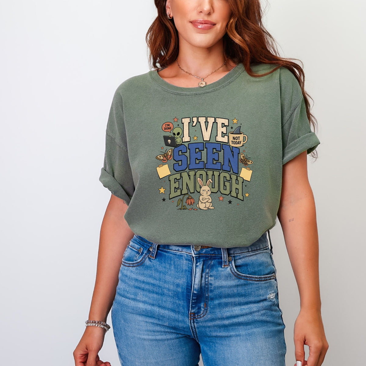 Green t-shirt with "I'VE SEEN ENOUGH" text and cartoon alien, mug, and bunny graphics.