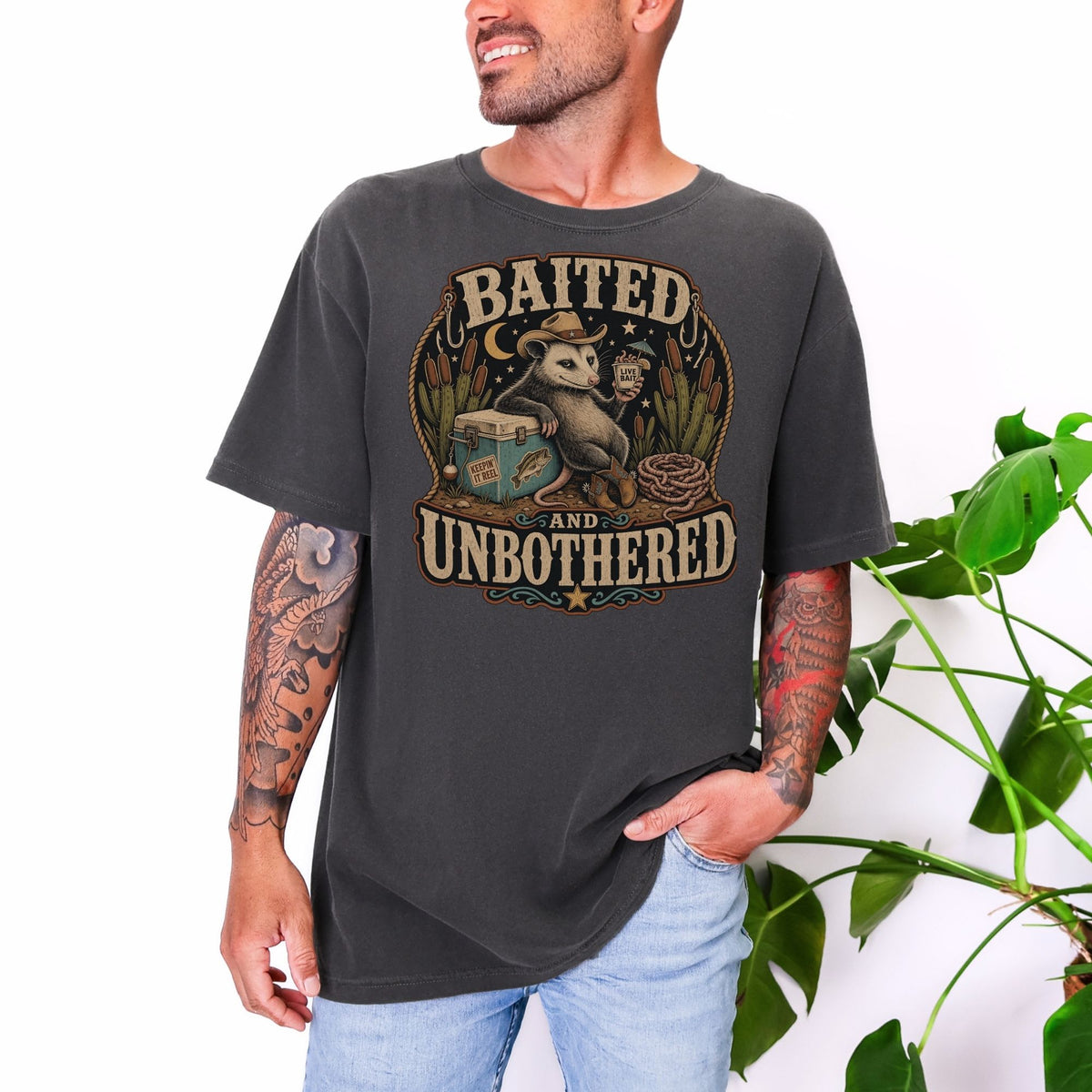 Opossum wearing cowboy hat holding a drink with text "Baited and Unbothered".
