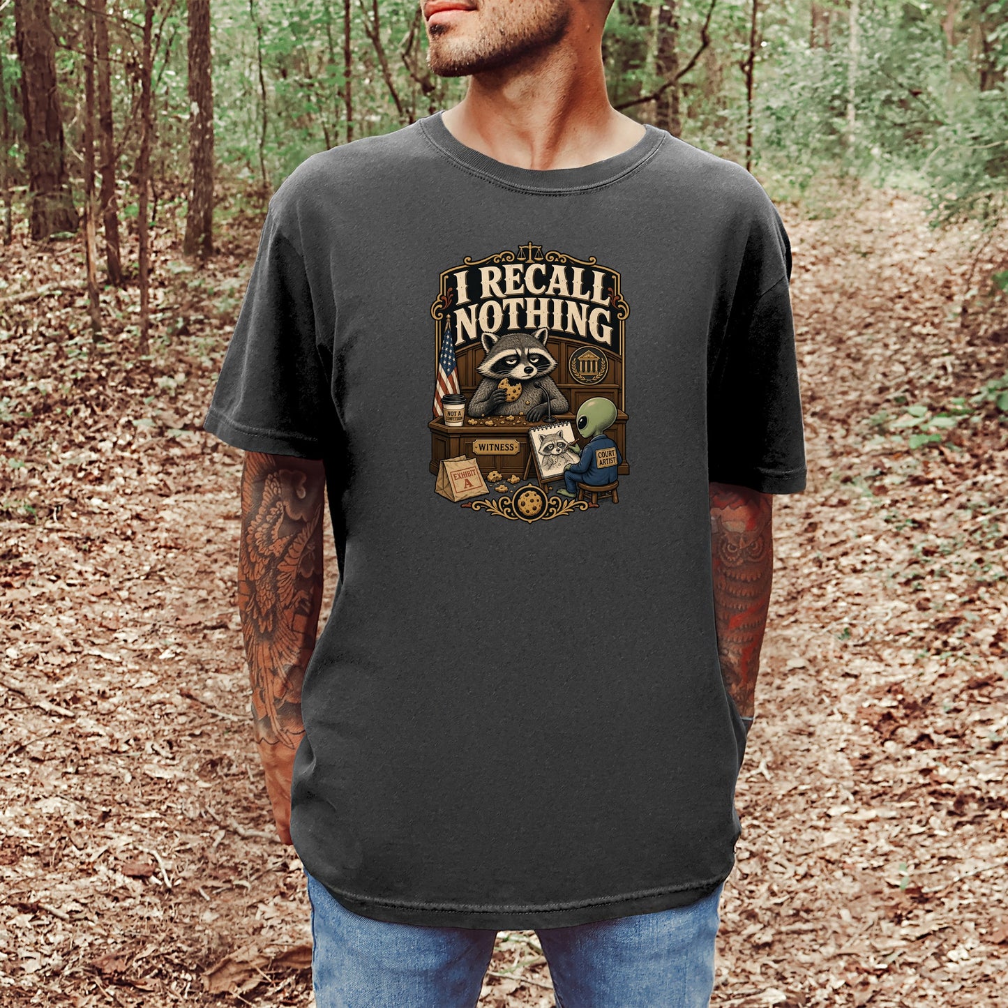 T-shirt graphic with raccoon claiming "I recall nothing" in a courtroom setting.