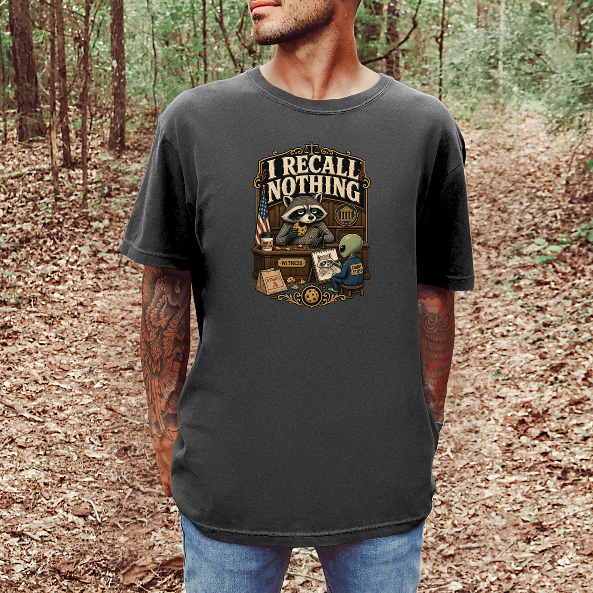 T-shirt graphic with raccoon claiming "I recall nothing" in a courtroom setting.
