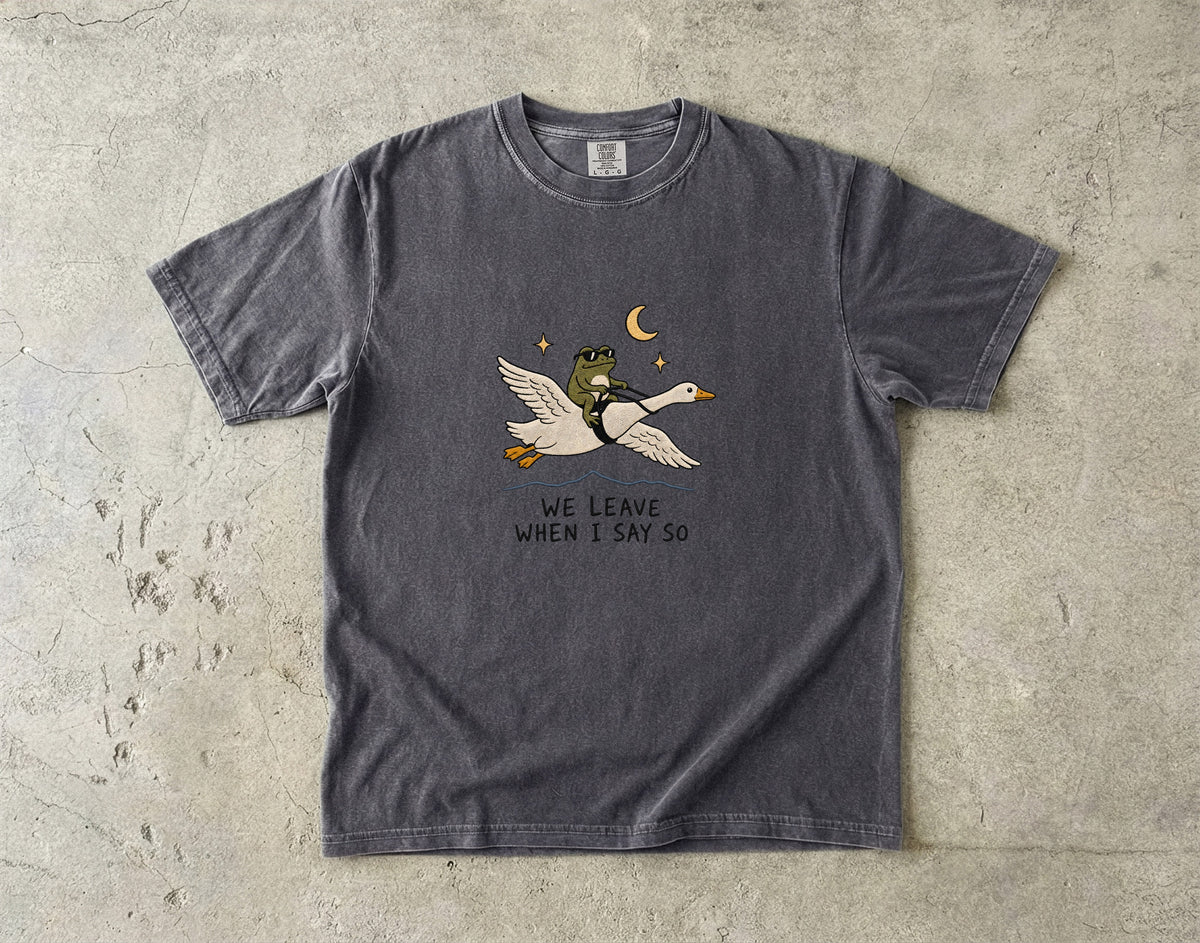 Dark gray t-shirt with a graphic of a frog riding a goose at night.