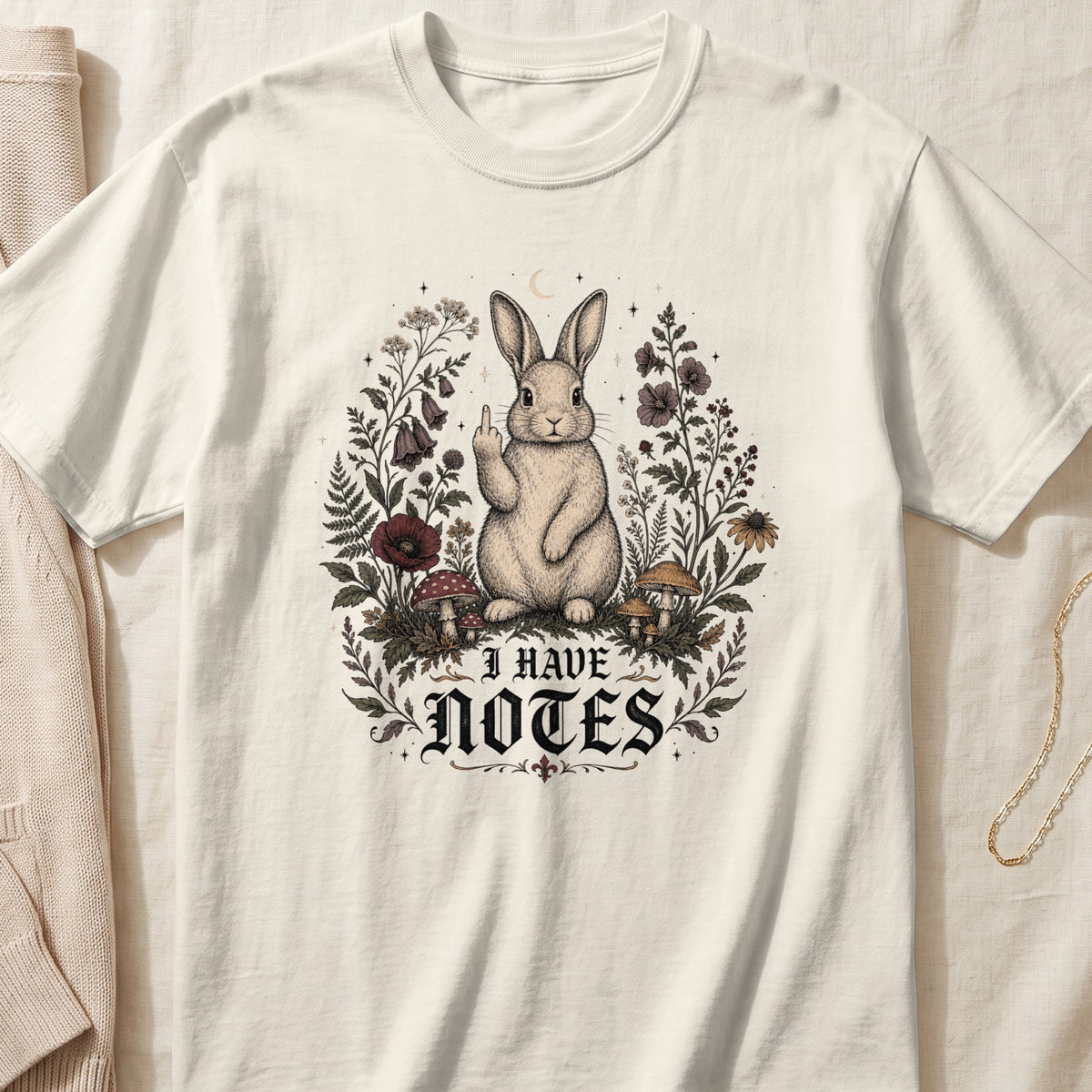 Cream t-shirt with a rabbit raising middle finger and "I HAVE NOTES" text.