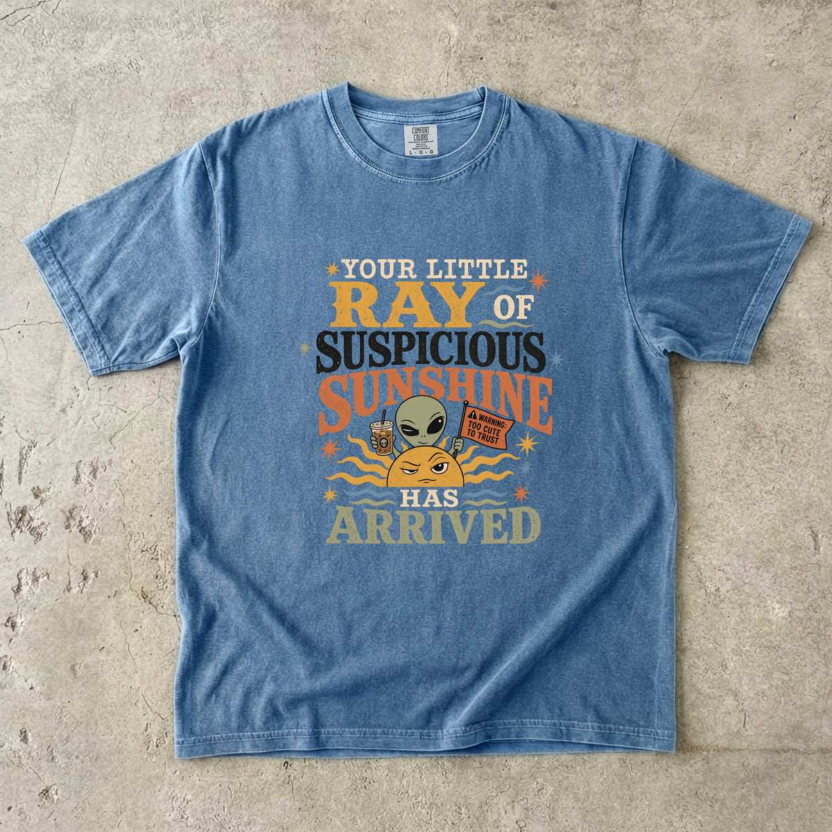 Blue t-shirt with "Your Little Ray of Suspicious Sunshine Has Arrived" text and graphics.