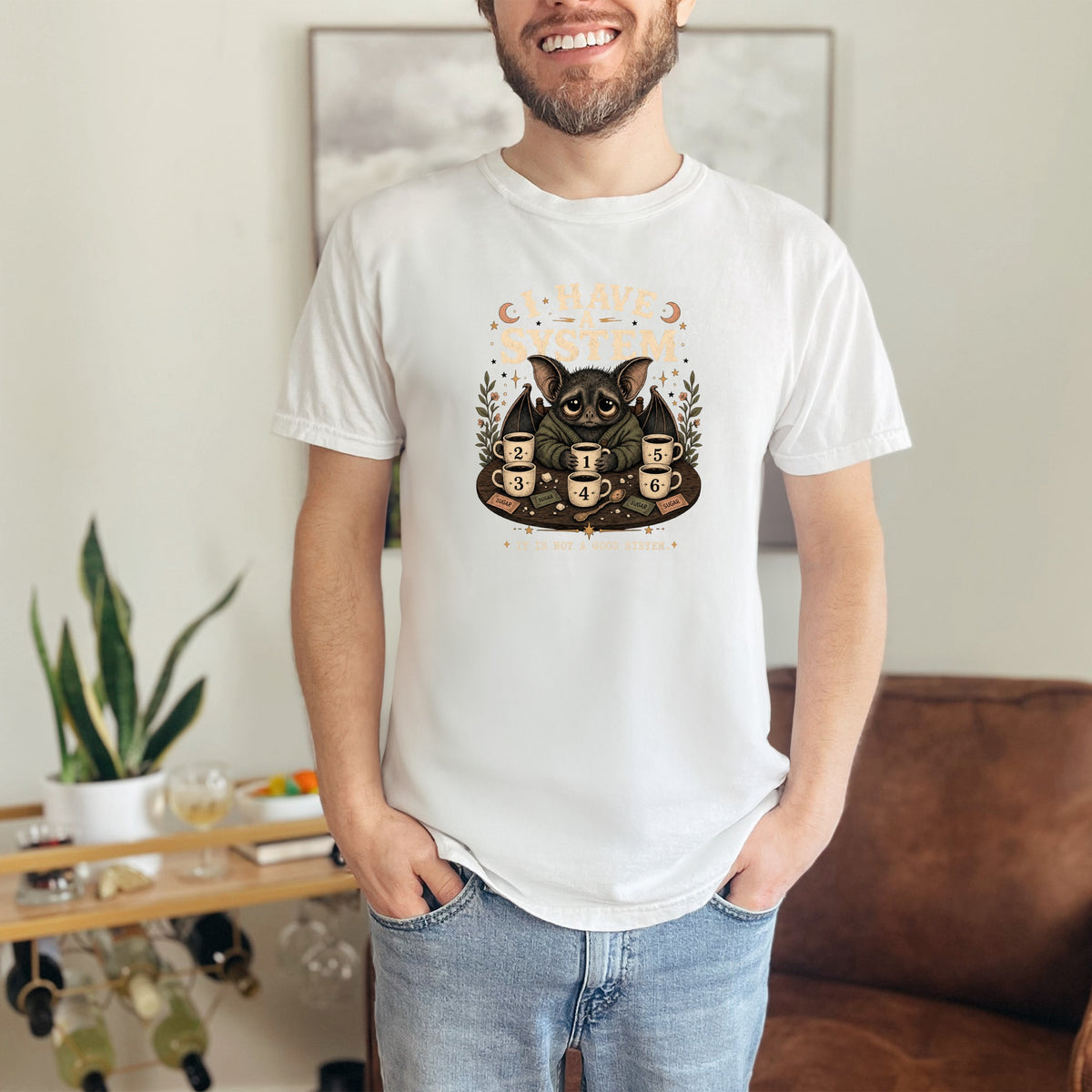 T-shirt graphic of a bat with "I HAVE A SYSTEM" and numbered coffee cups.