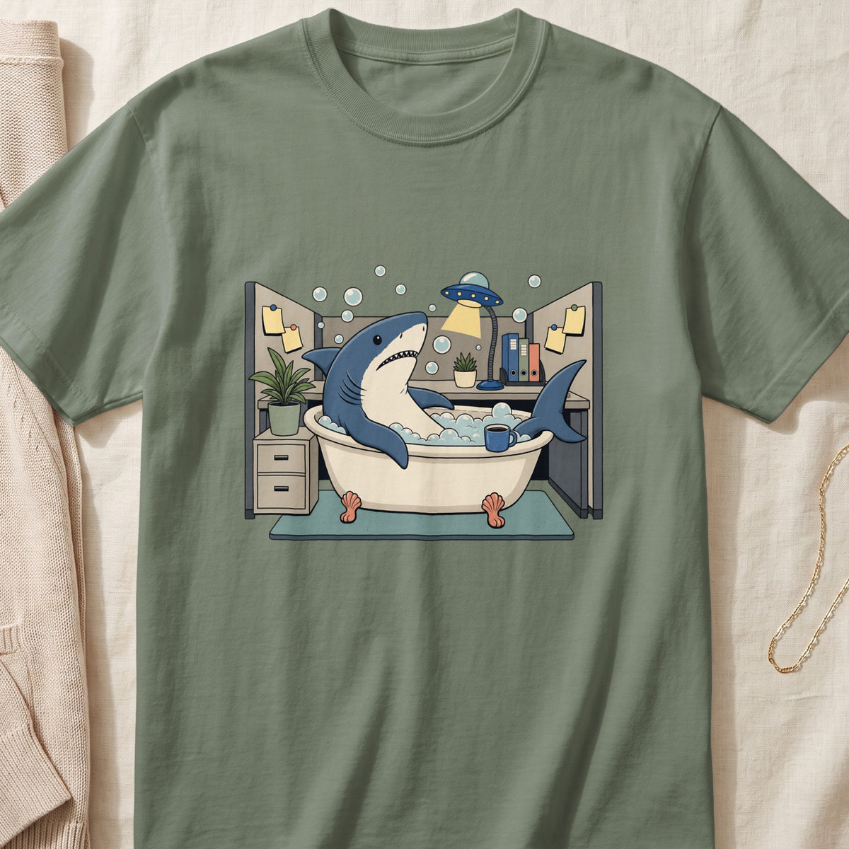 Cartoon shark in a bathtub with a UFO lamp and coffee cup in an office cubicle.