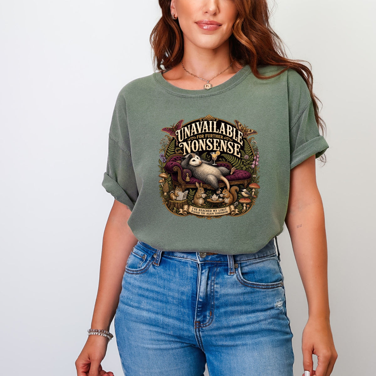 Green t-shirt with graphic: possum on couch with text "Unavailable for further nonsense."