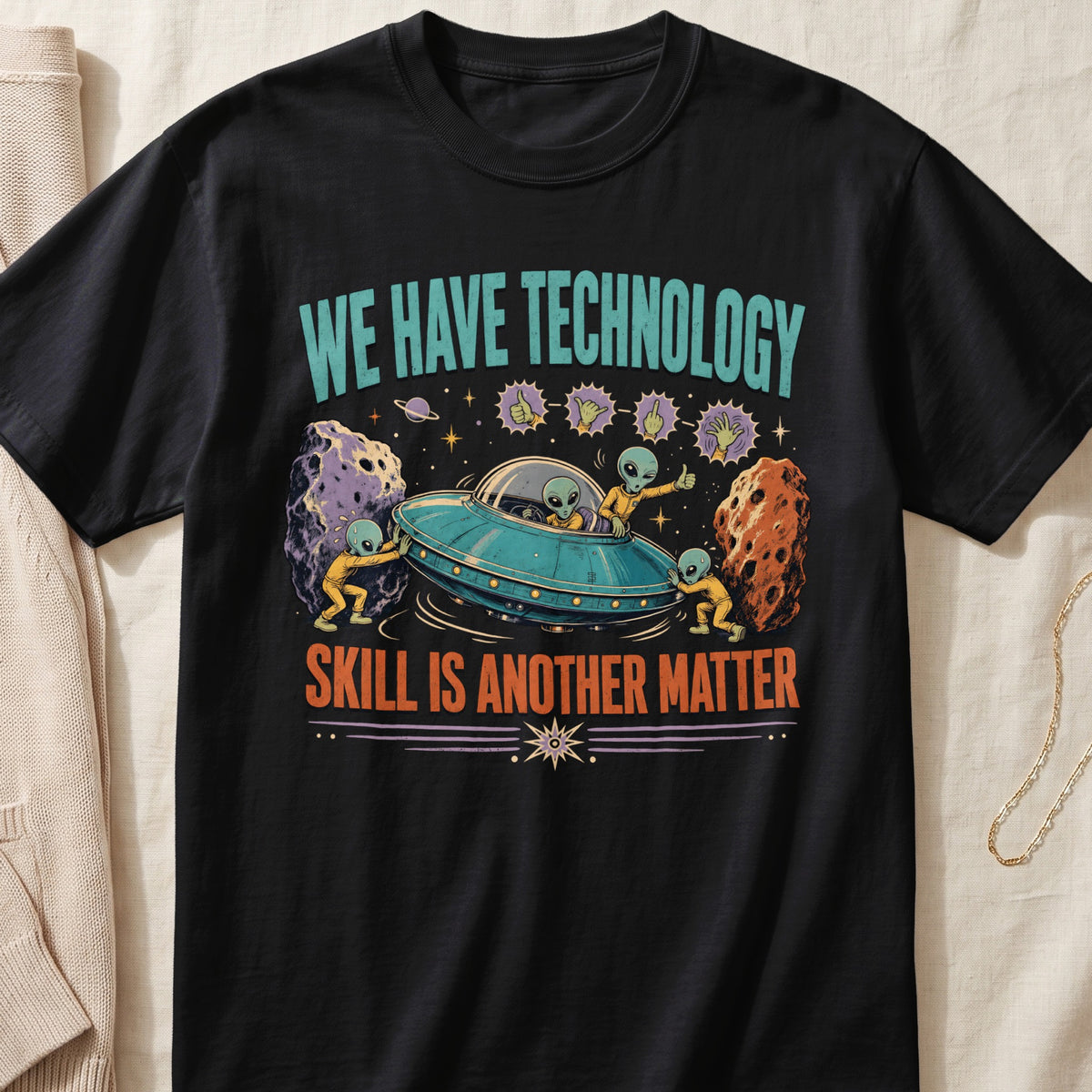 Black t-shirt with aliens, a UFO, meteors, and text "WE HAVE TECHNOLOGY SKILL IS ANOTHER MATTER".