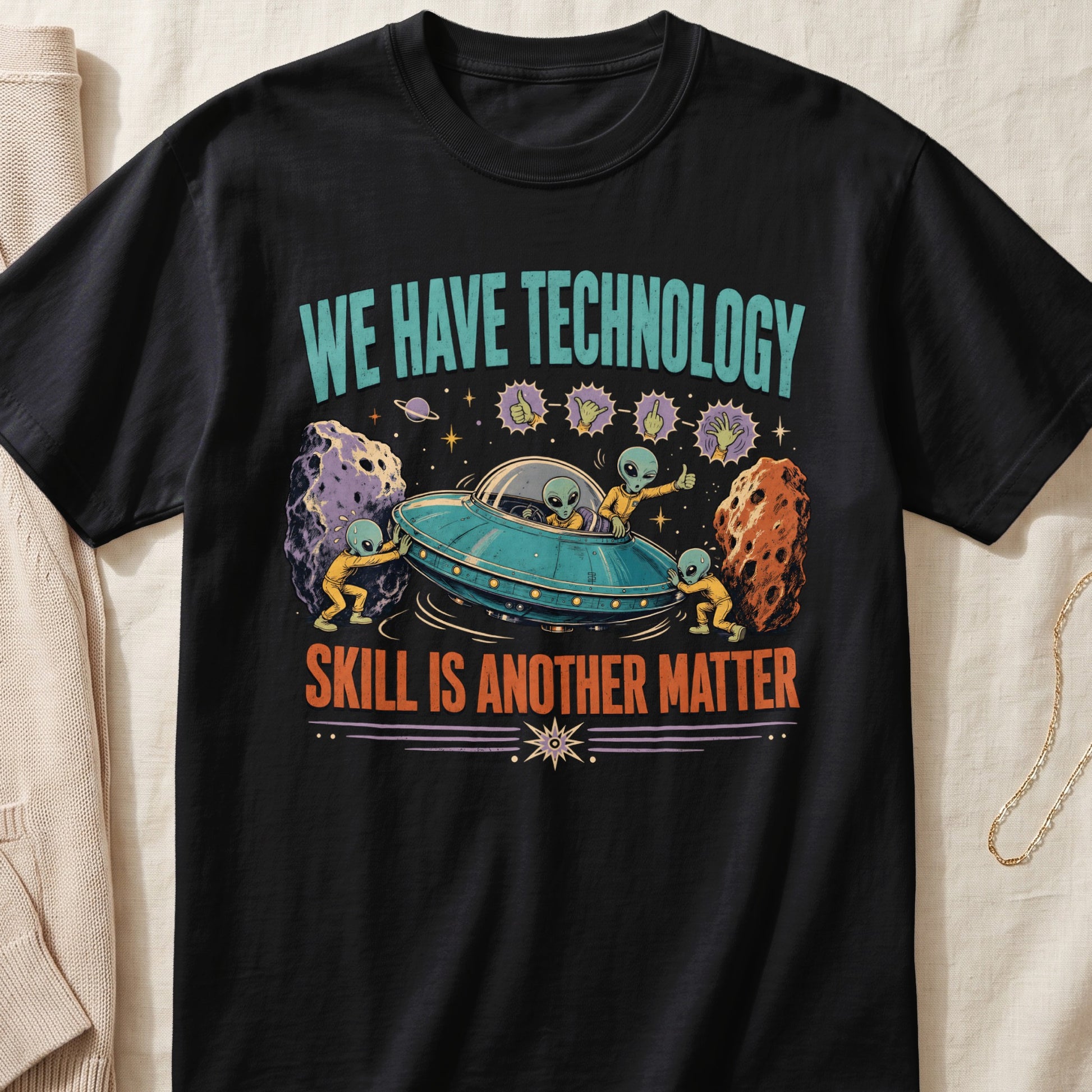 Black t-shirt with aliens, a UFO, meteors, and text "WE HAVE TECHNOLOGY SKILL IS ANOTHER MATTER".
