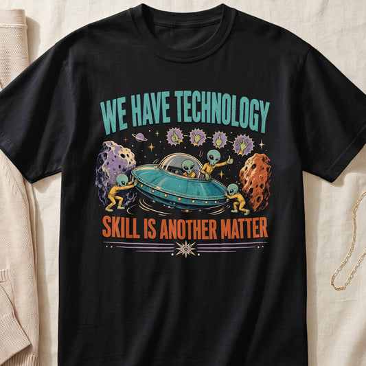 Black t-shirt with aliens, a UFO, meteors, and text "WE HAVE TECHNOLOGY SKILL IS ANOTHER MATTER".