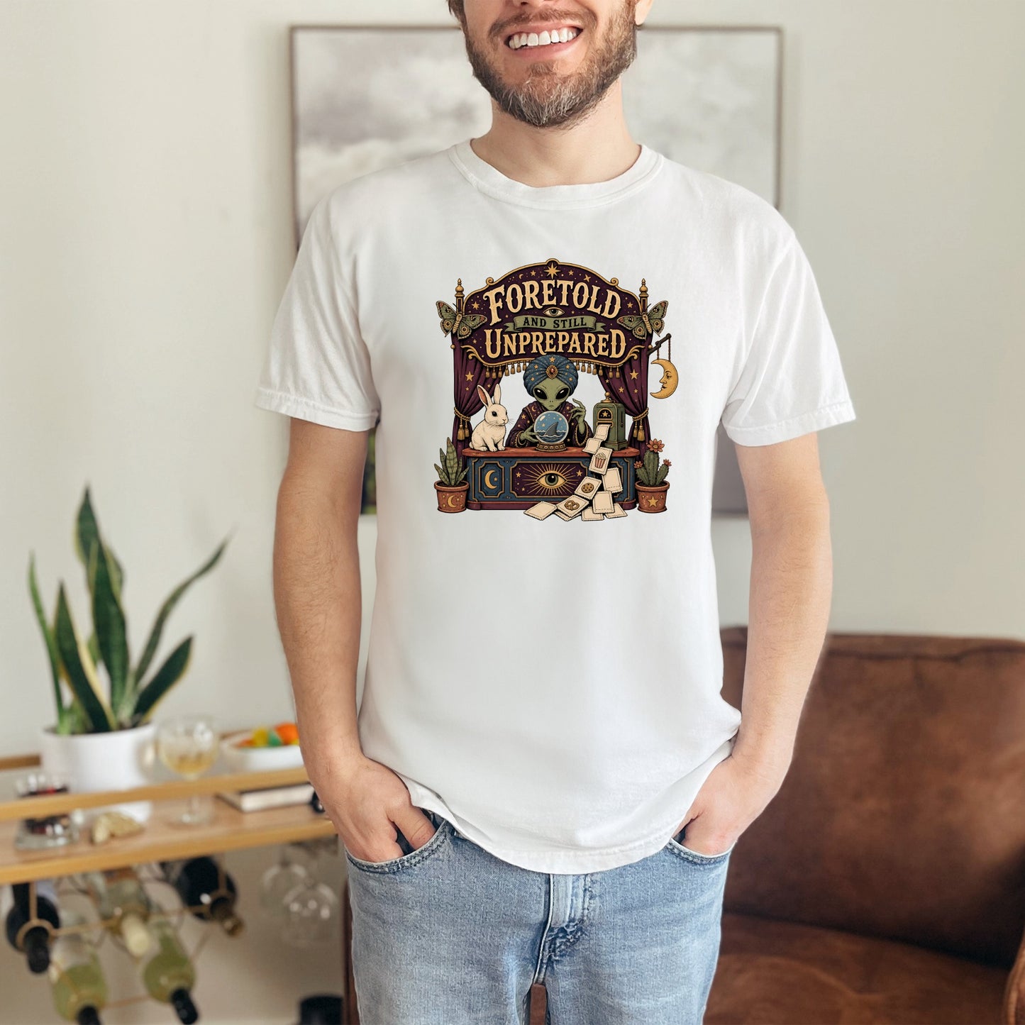 White t-shirt with a mystical fortune teller graphic featuring an alien, rabbit, and moon.